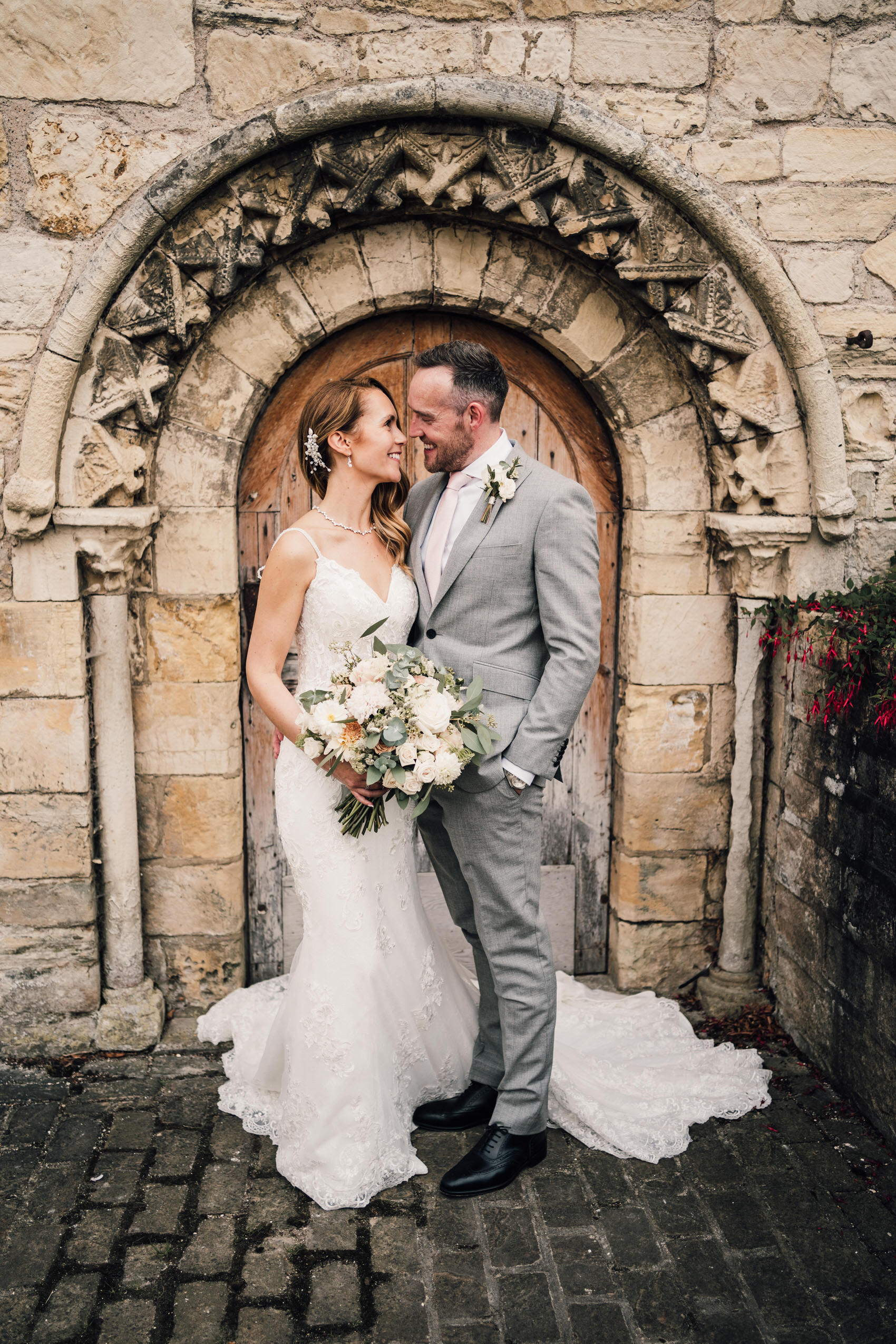 bride and groom in priory barn and cottages courtyard