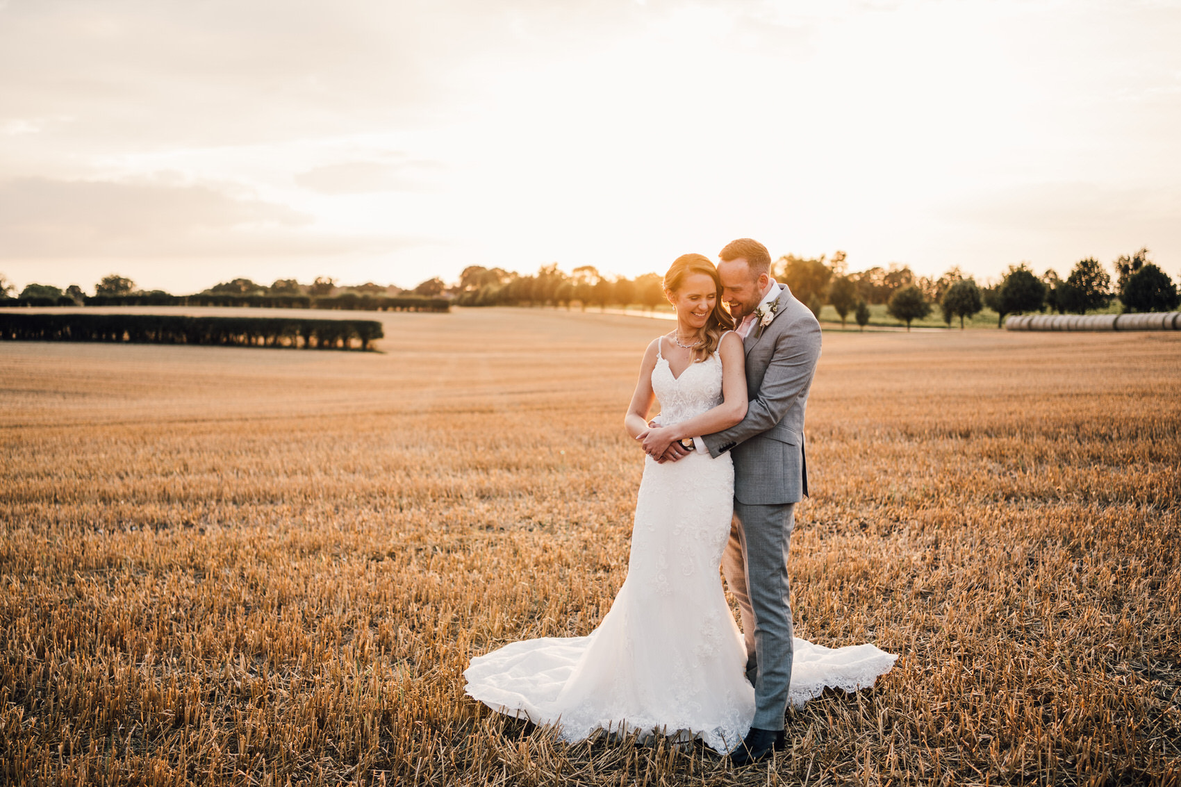 bride and groom in corn field