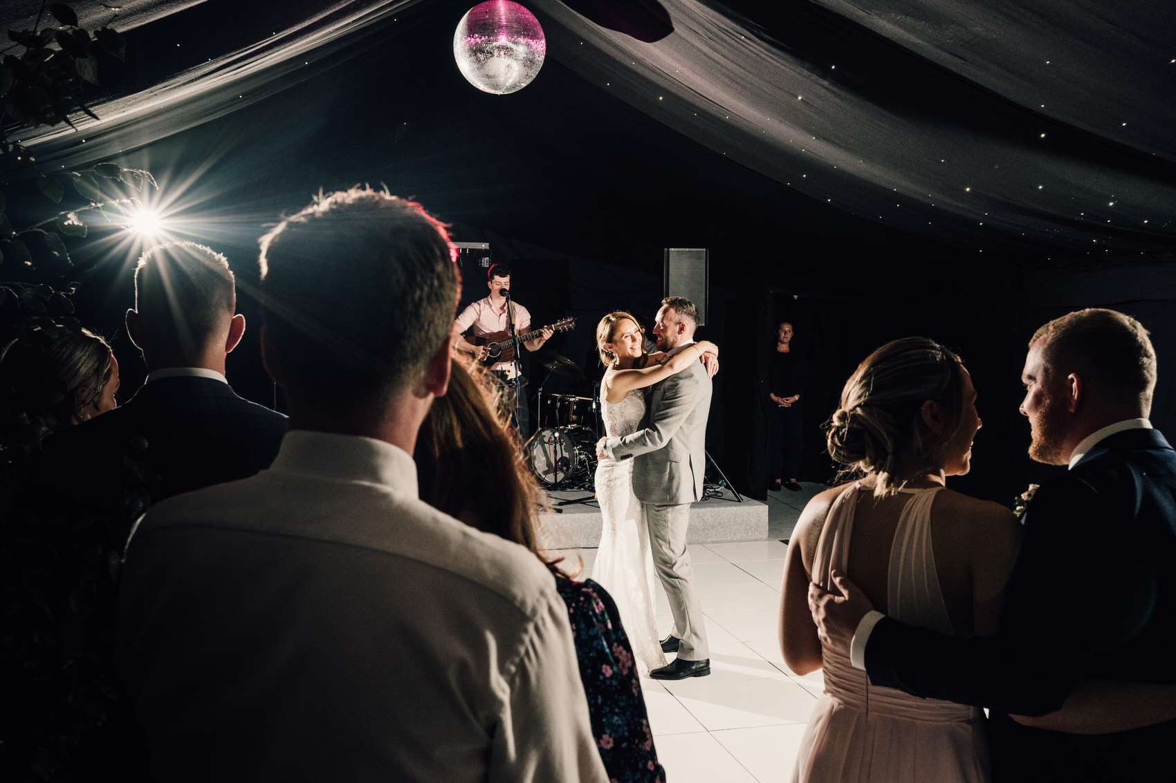 bride and groom dancing while crowd watches