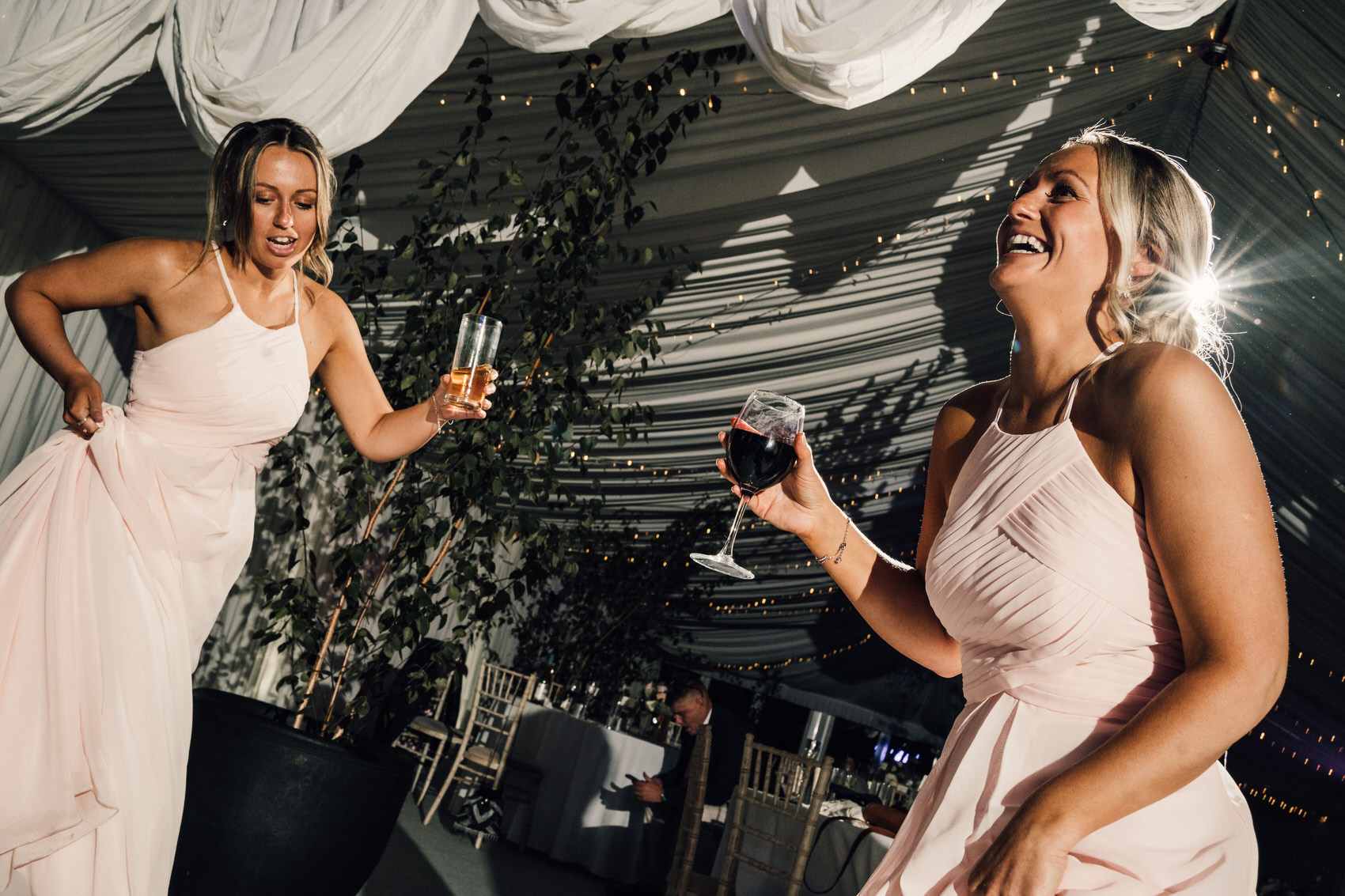 bridesmaids with drinks on dancefloor